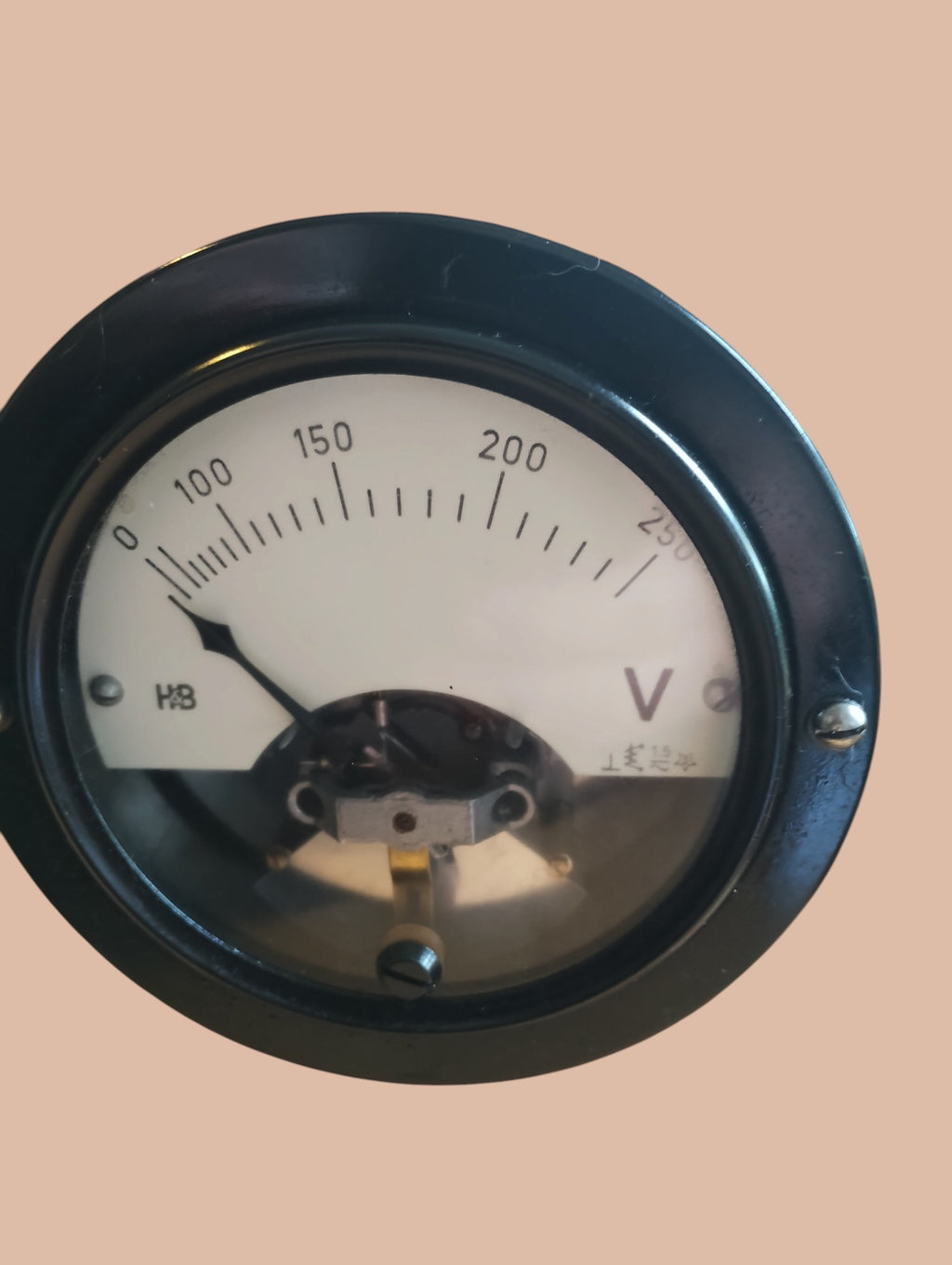 Close-up of the Hartmann & Braun voltmeter dial with a 0–250 V scale, pointer, and black bezel
