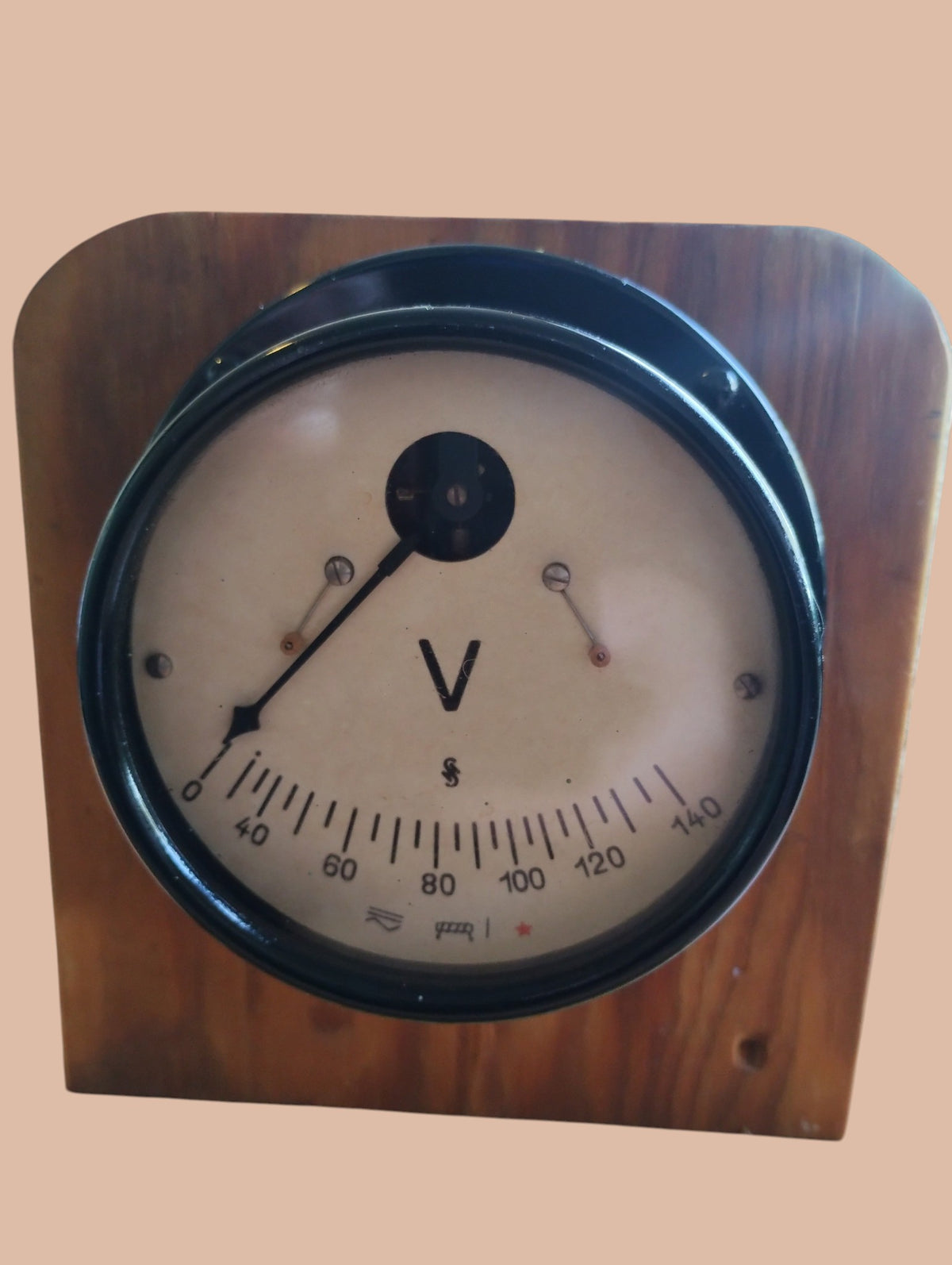 Close-up of the vintage AC voltmeter dial with a 0–140 V scale, pointer, and black metal bezel.
