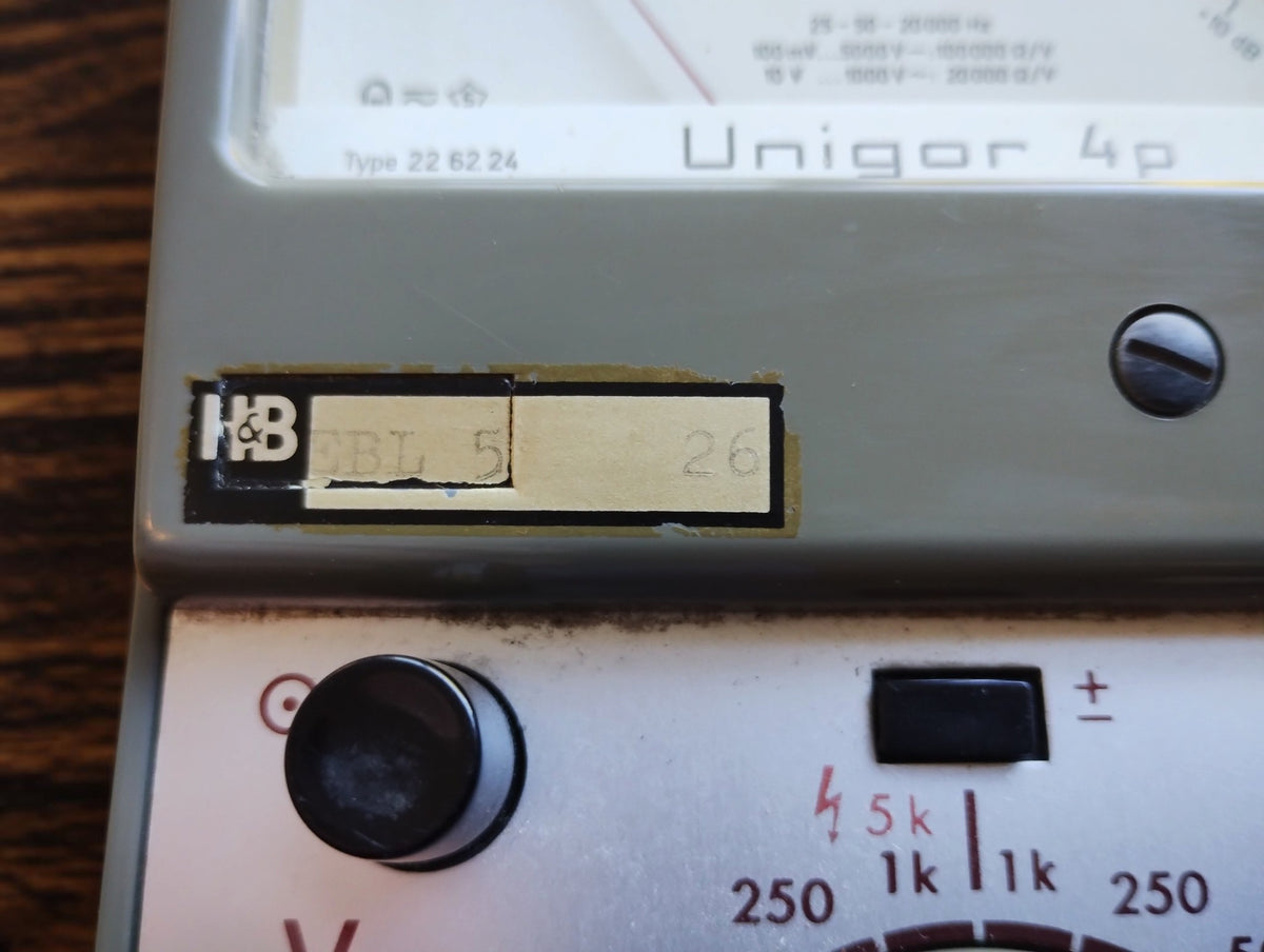 Close-up of the H&B marking on the Unigor 4p analog multimeter housing below the measurement scale
