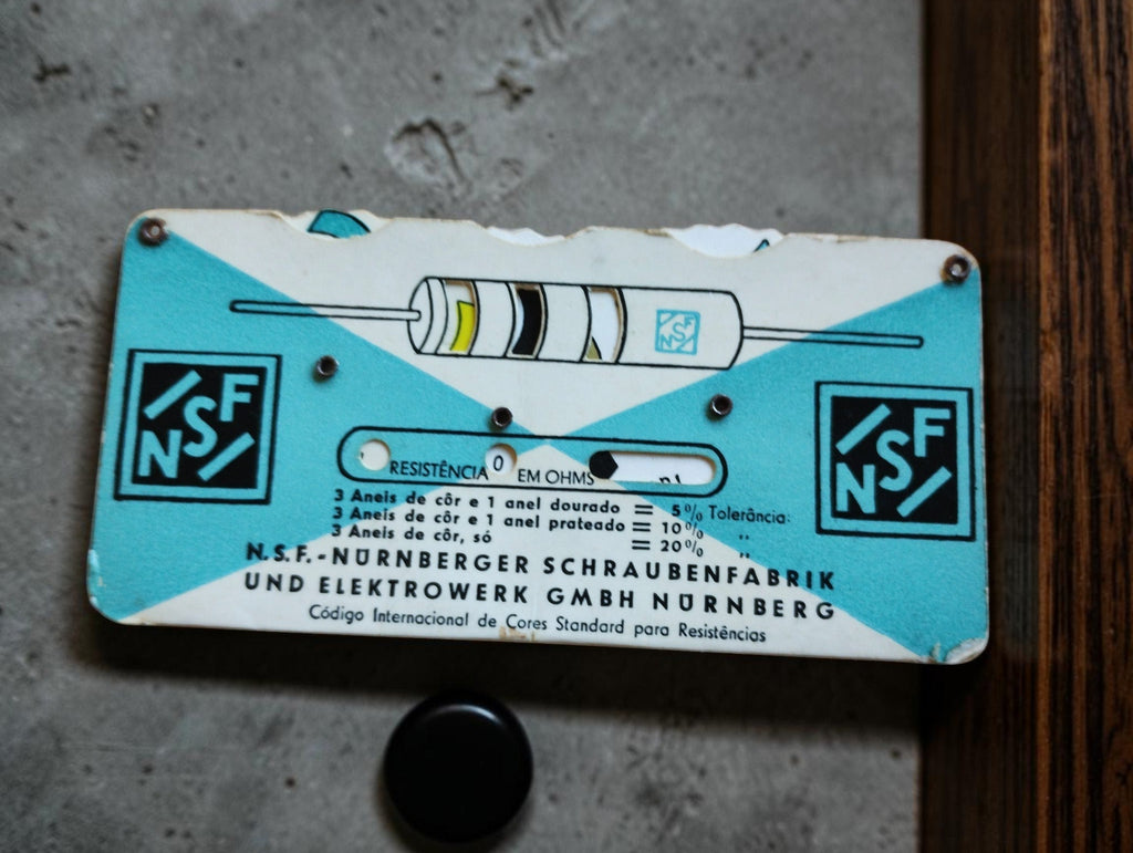 Vintage NSF Nürnberg resistor color code slide with resistance markings and visible wear
