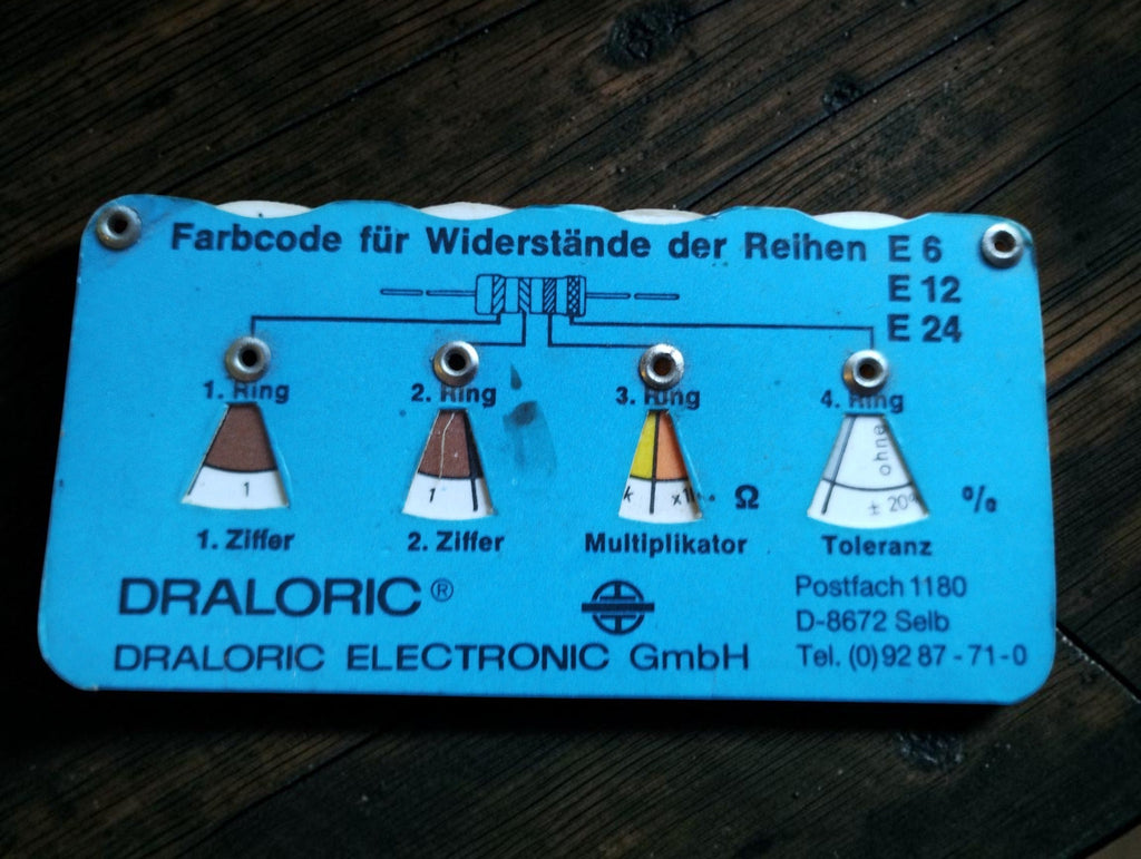 Blue vintage Draloric resistor color-code calculator for E6, E12 and E24 series, showing resistance multiplier and tolerance
