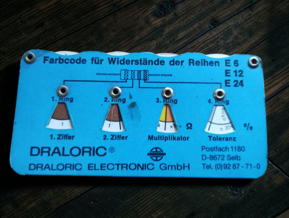 Blue vintage Draloric resistor color-code calculator for E6, E12 and E24 series, showing resistance multiplier and tolerance
