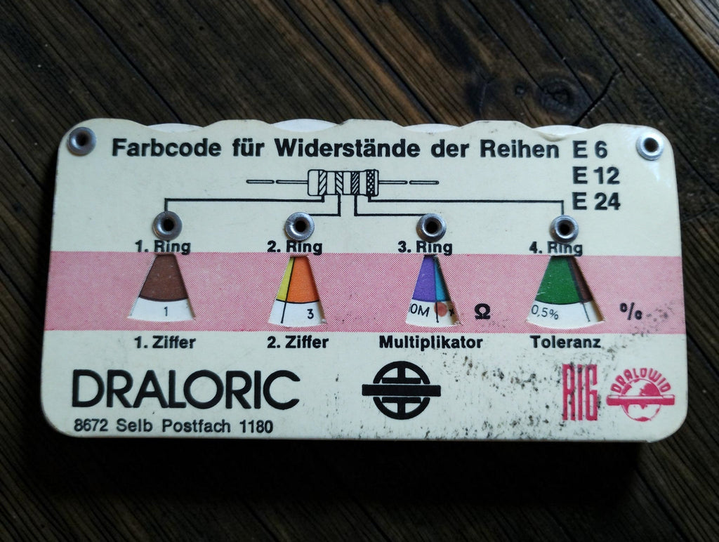 White and pink vintage Draloric resistor color-code calculator for E6, E12 and E24 series with visible age-related wear
