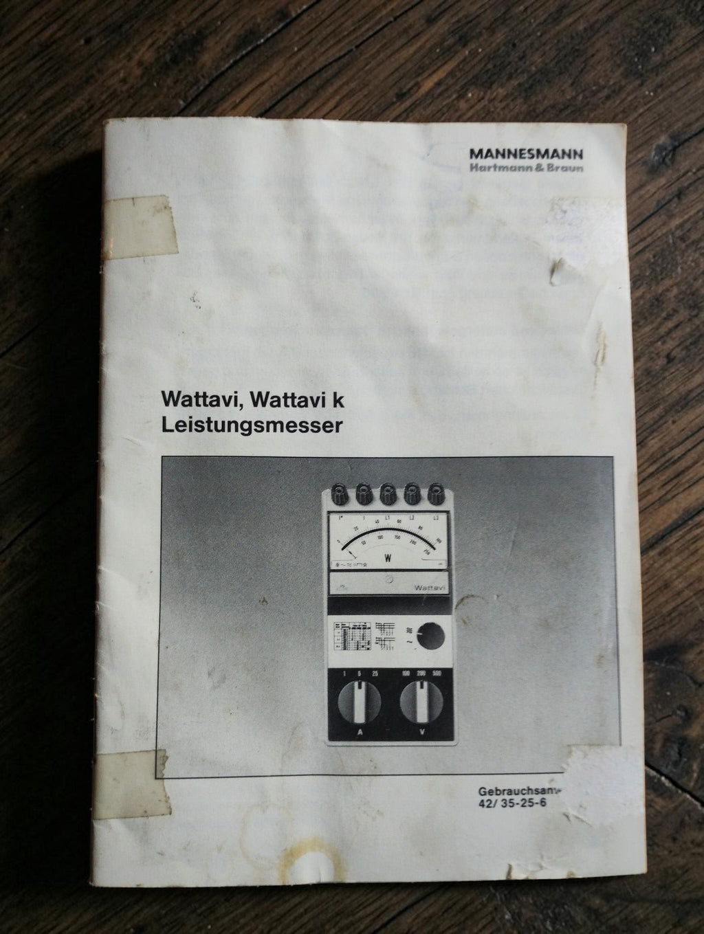 Original Mannesmann Hartmann & Braun instruction manual for Wattavi and Wattavi k wattmeters, showing wear and tape repairs
