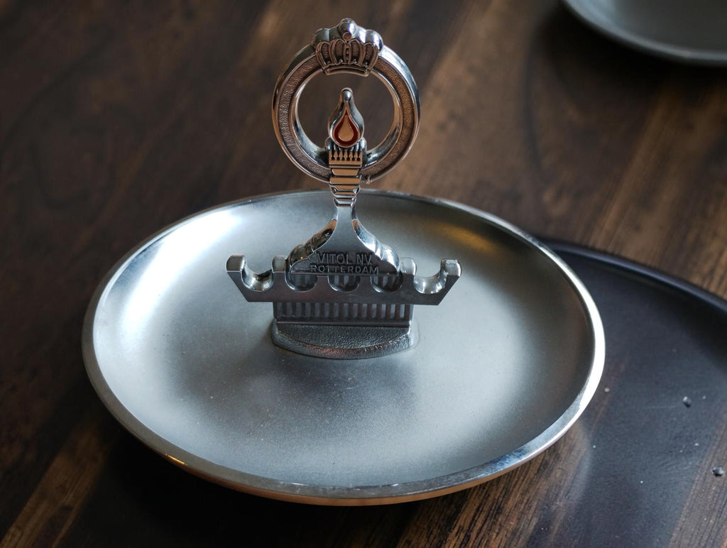 Vintage Vitol N.V. Rotterdam pipe ashtray with integrated pipe rack, crown and orange flame motif, front view
