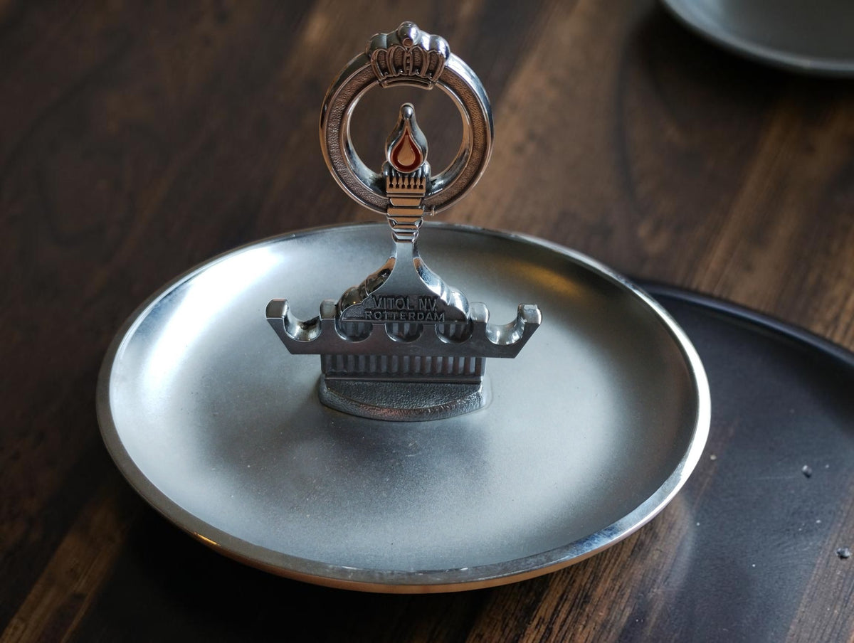 Vintage Vitol N.V. Rotterdam pipe ashtray with integrated pipe rack, crown and orange flame motif, front view
