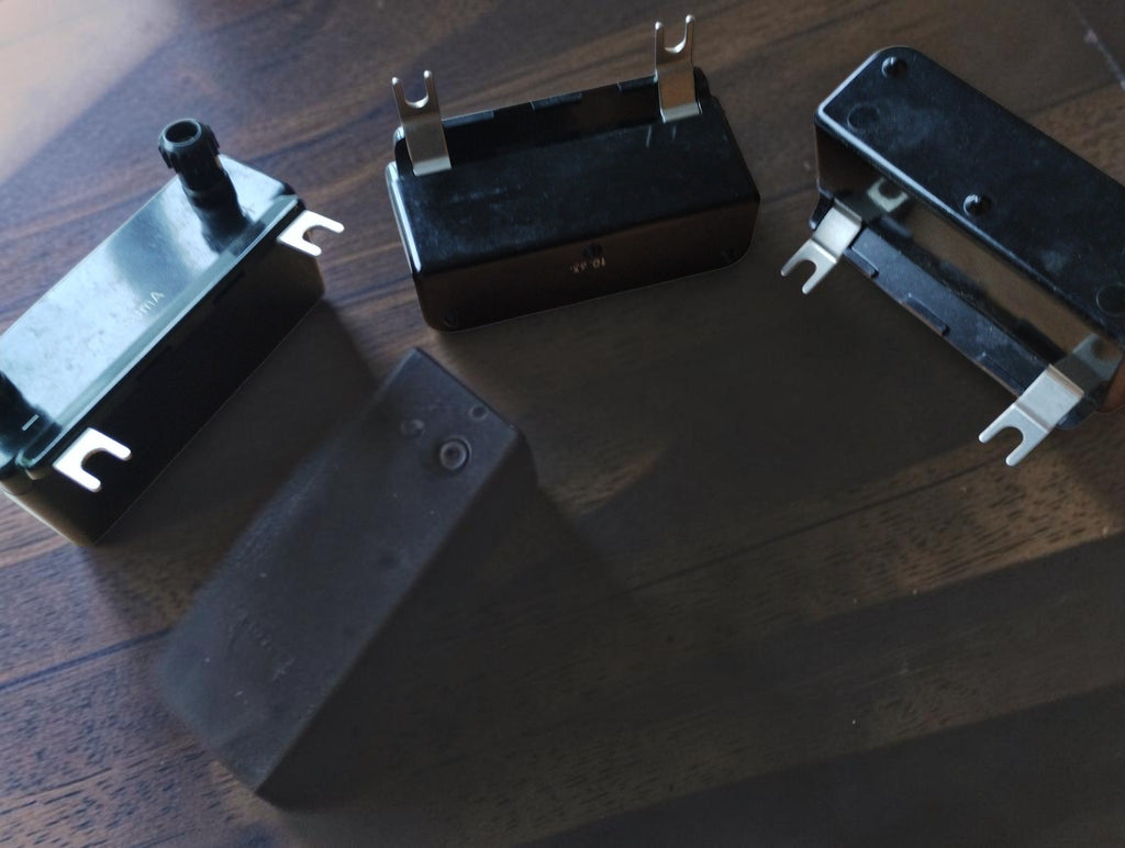 Side and underside views of vintage measuring range modules with black housings, terminals, and fork contacts
