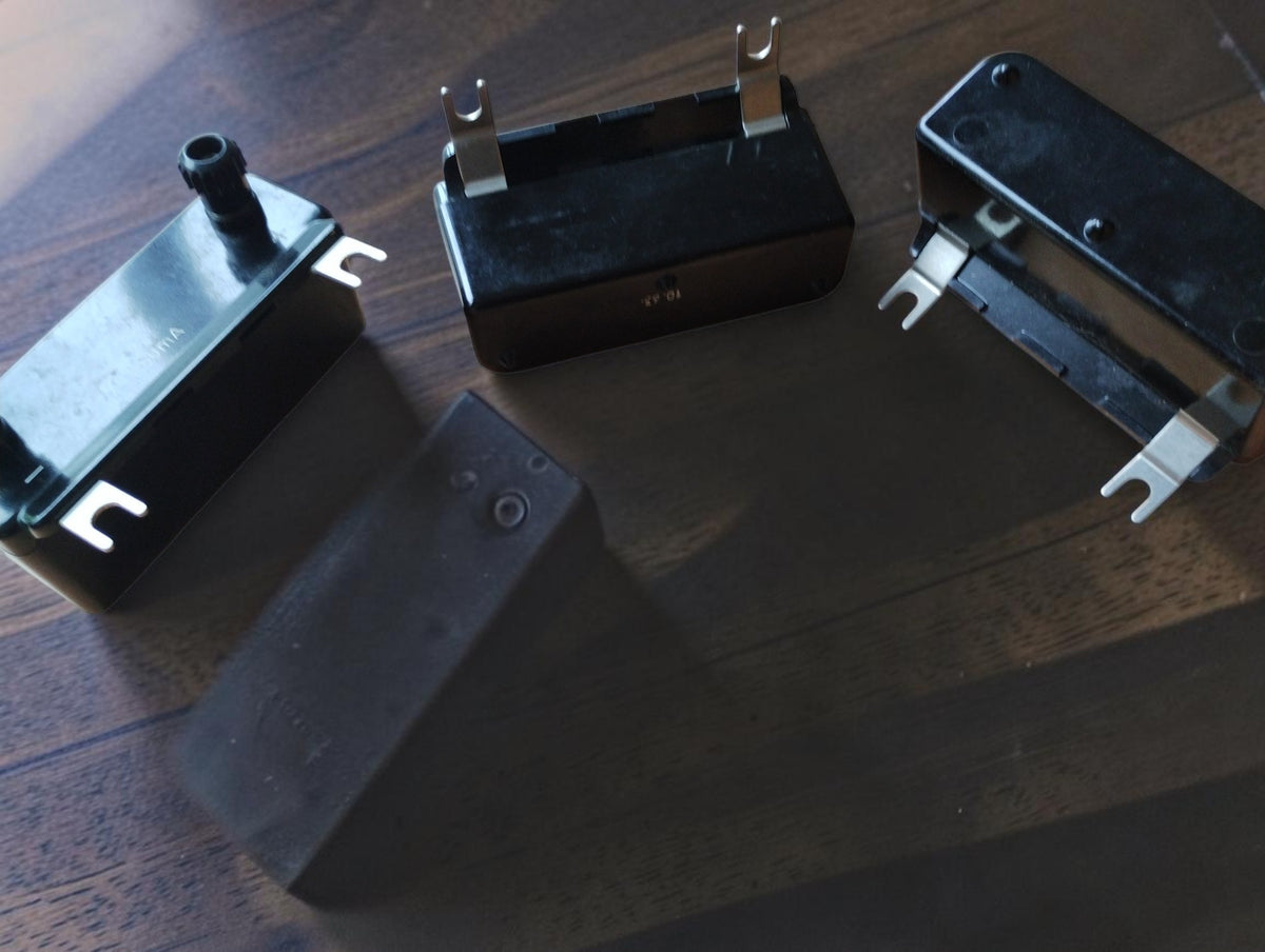 Side and underside views of vintage measuring range modules with black housings, terminals, and fork contacts
