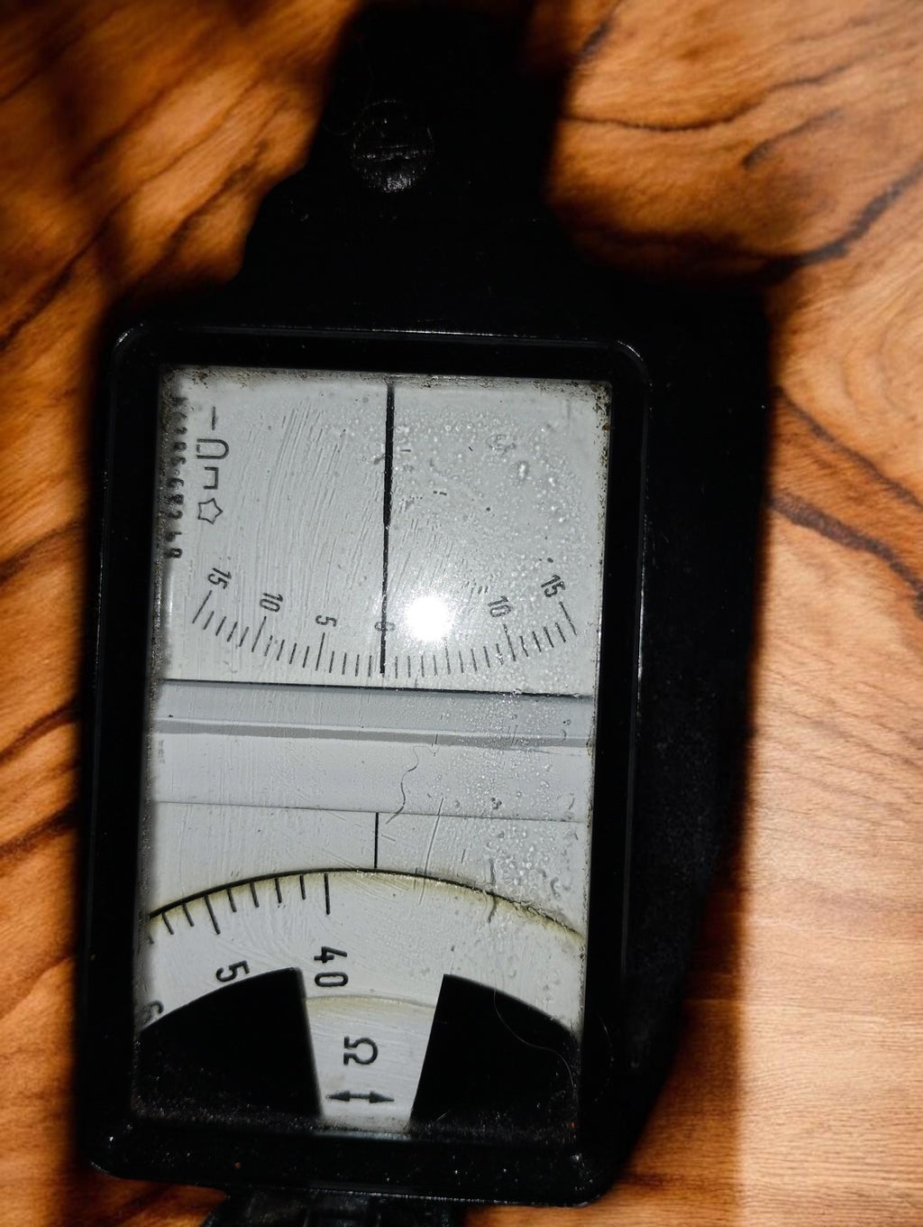 Close-up of the Siemens & Halske resistance bridge meter window, pointer and ohm scale
