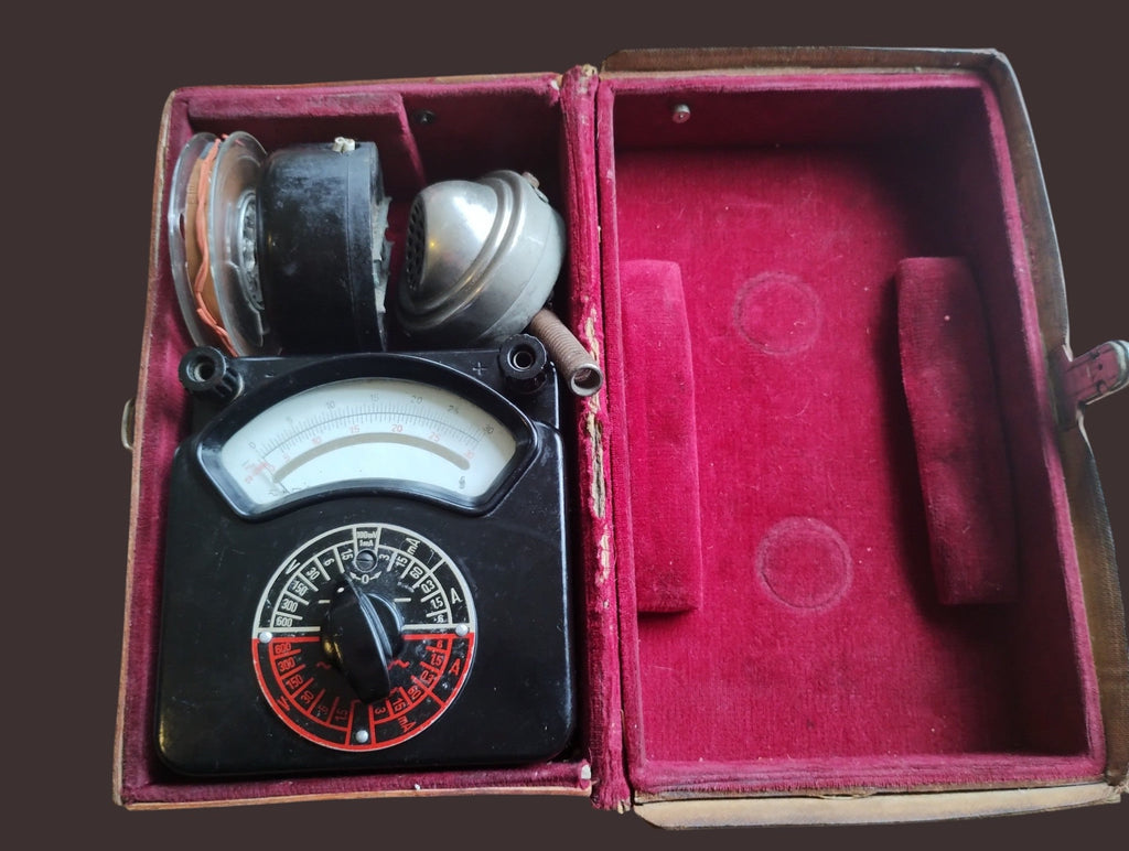 Siemens & Halske Post Multizet 1 test set with analog meter and telephone test accessories in an open red plush-lined case.

