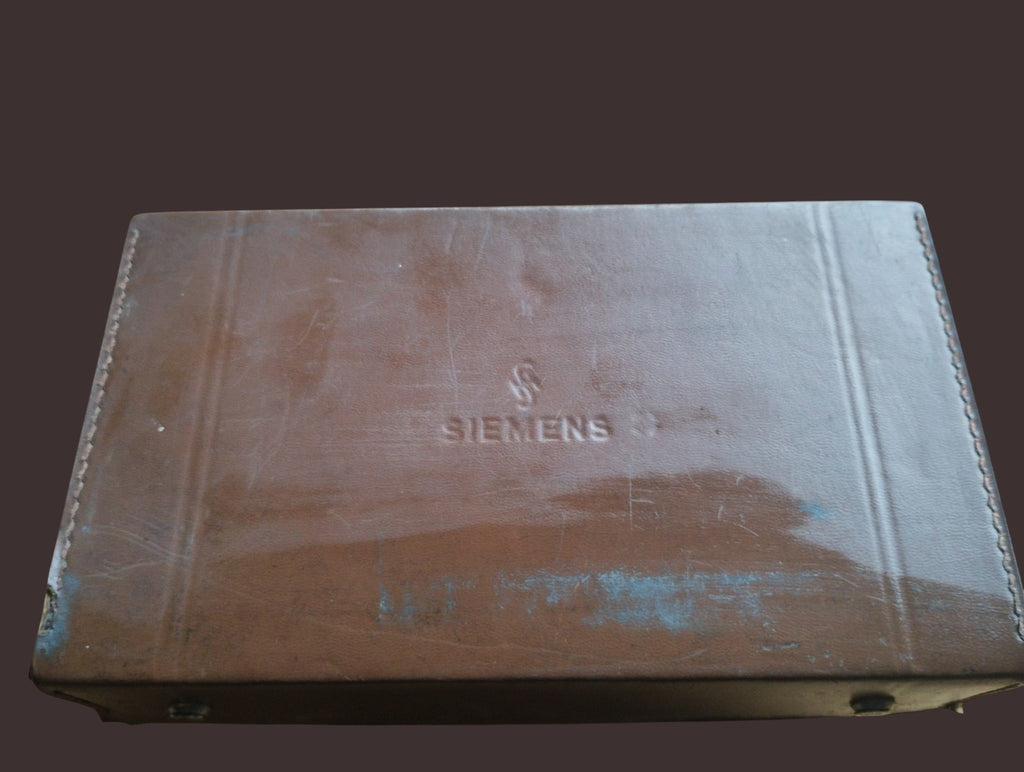 Closed brown Siemens carrying case with embossed branding and visible surface wear.
