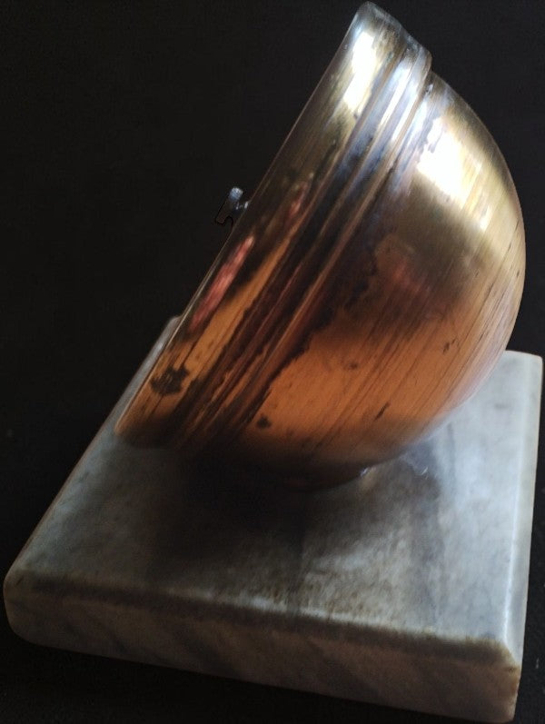 Side view of the desk barometer showing its curved brass case, aged finish, and marble base.
