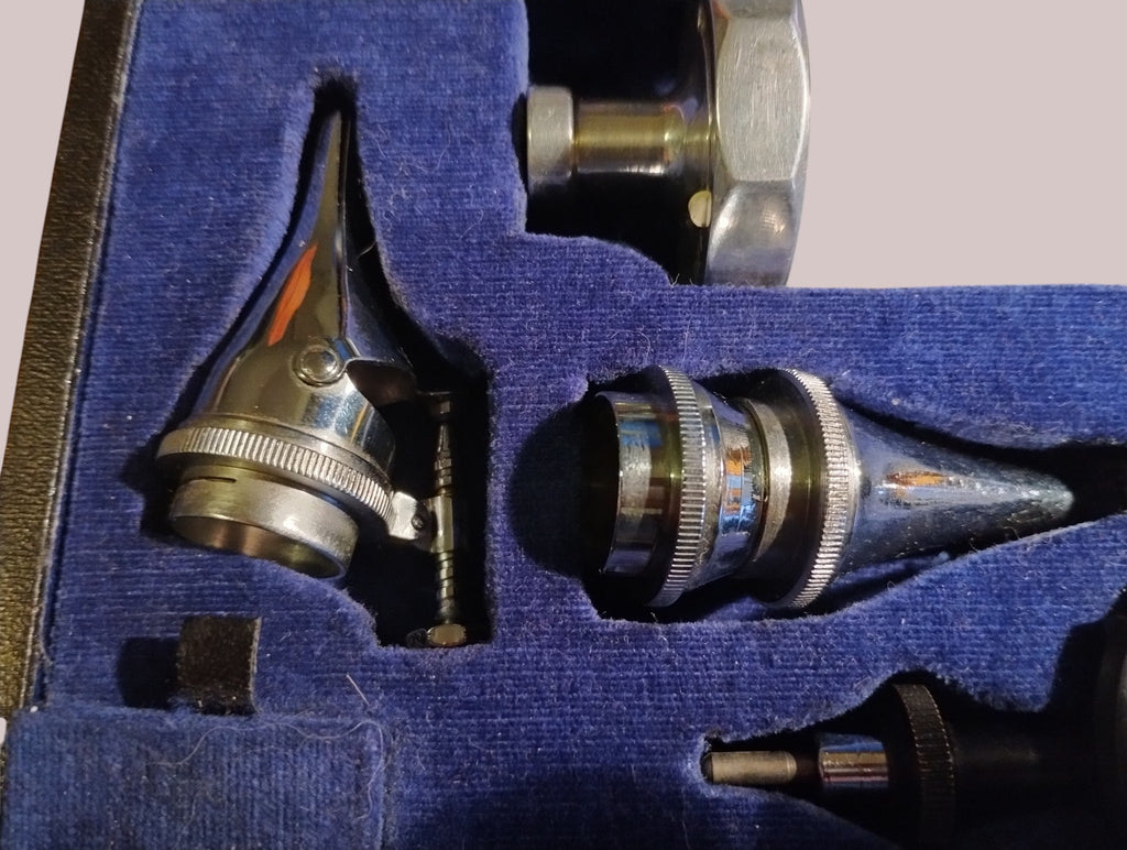 Two metal instrument attachments in the fitted blue lining of a Gowllands diagnostic set

