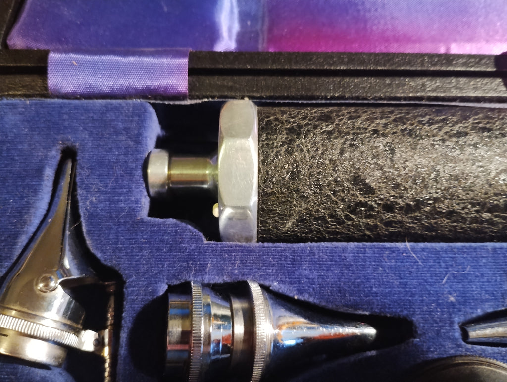Textured black handle with metal end fitting and instrument attachments in the Gowllands diagnostic case
