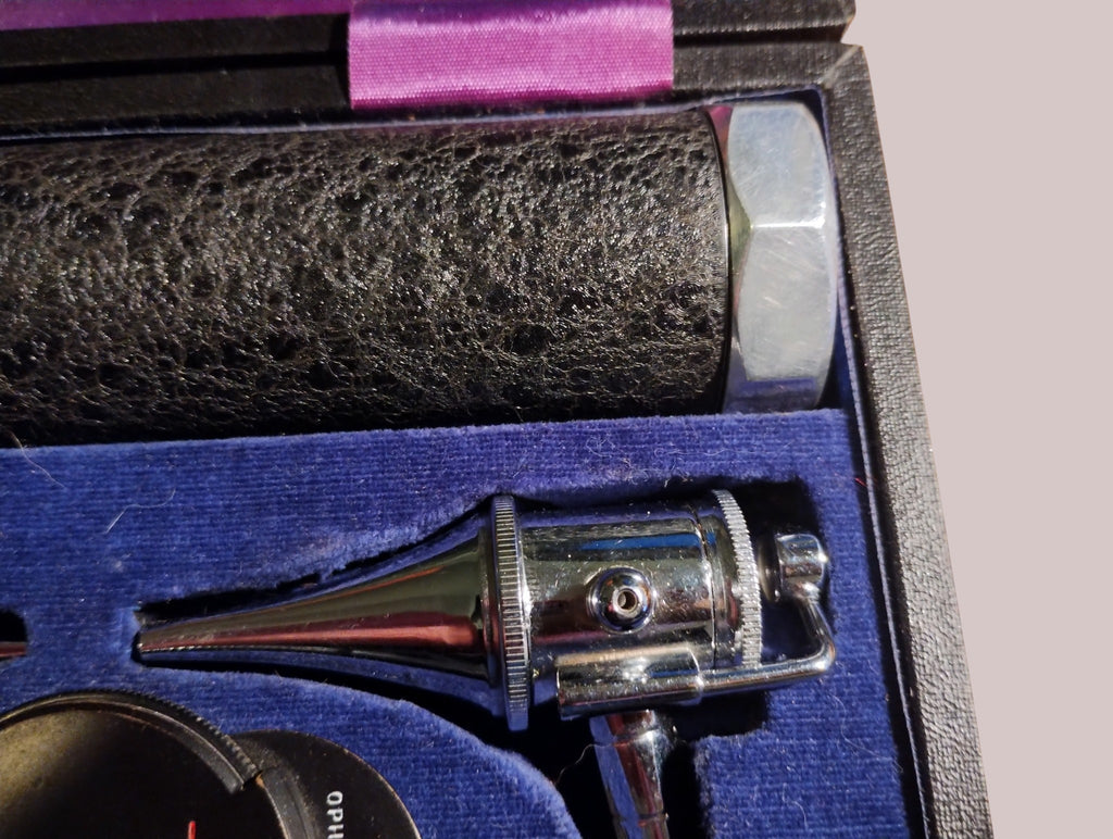 Close-up of a conical metal instrument head with a side opening in the Gowllands diagnostic set
