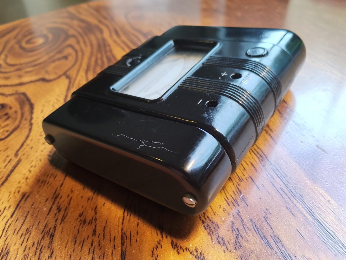 Angled view of the Gossen Megohm 60 V meter showing its ribbed black Bakelite case and connection sockets
