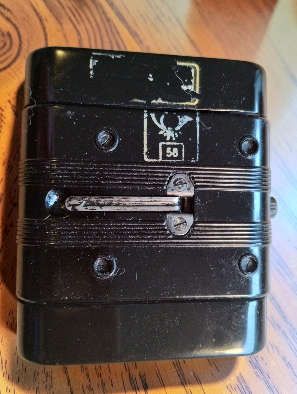Rear of the Gossen megohmmeter with a metal clip, eagle stamp marked 58 and worn label remnants
