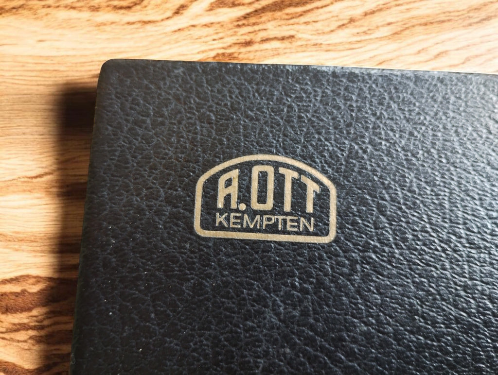Close-up of the A. OTT Kempten logo on the textured black planimeter case
