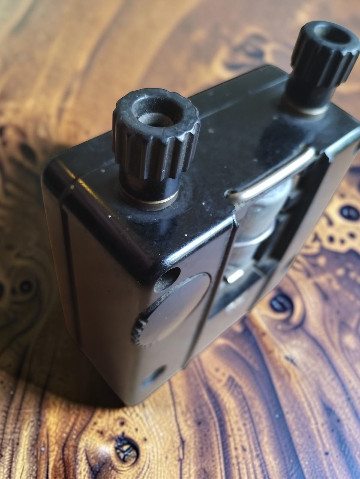 Angled view of the Siemens analog ohmmeter showing the black housing, two terminals, and metal carrying handle.
