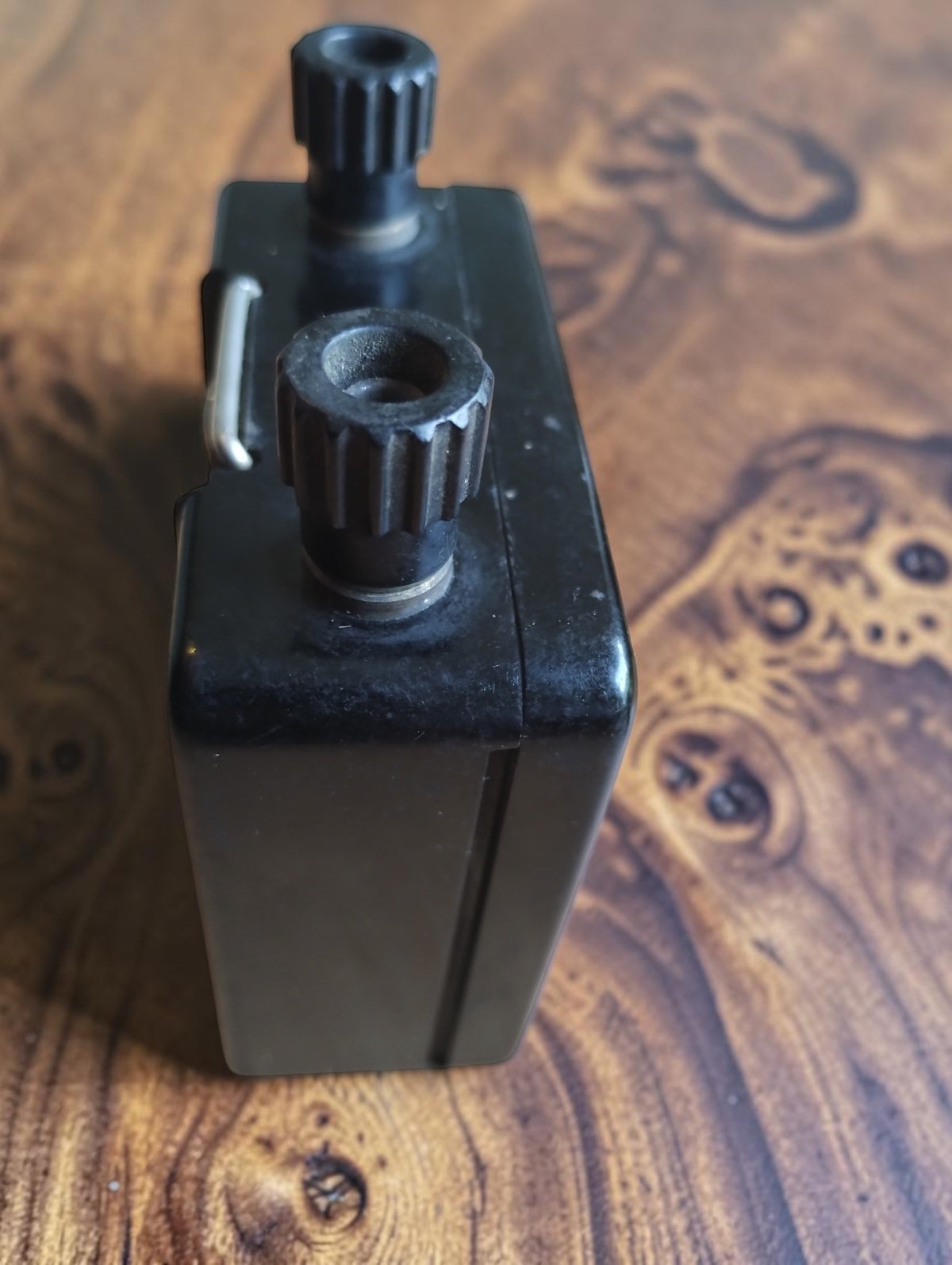 Side view of the Siemens vintage ohmmeter showing the housing seam, top terminals, and metal carrying handle.
