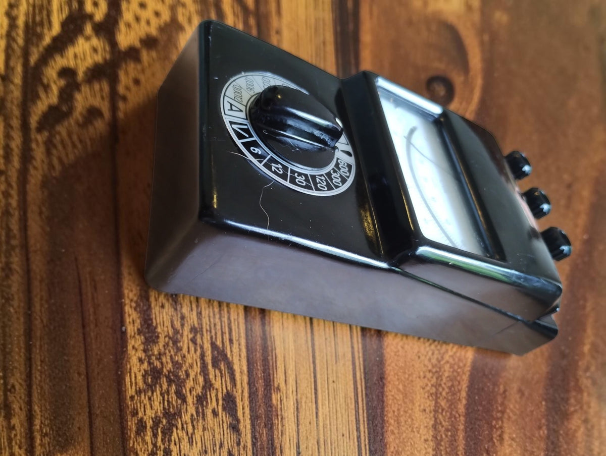 Angled side view of the vintage Gossen UVA multimeter showing its black housing and rotary range selector.
