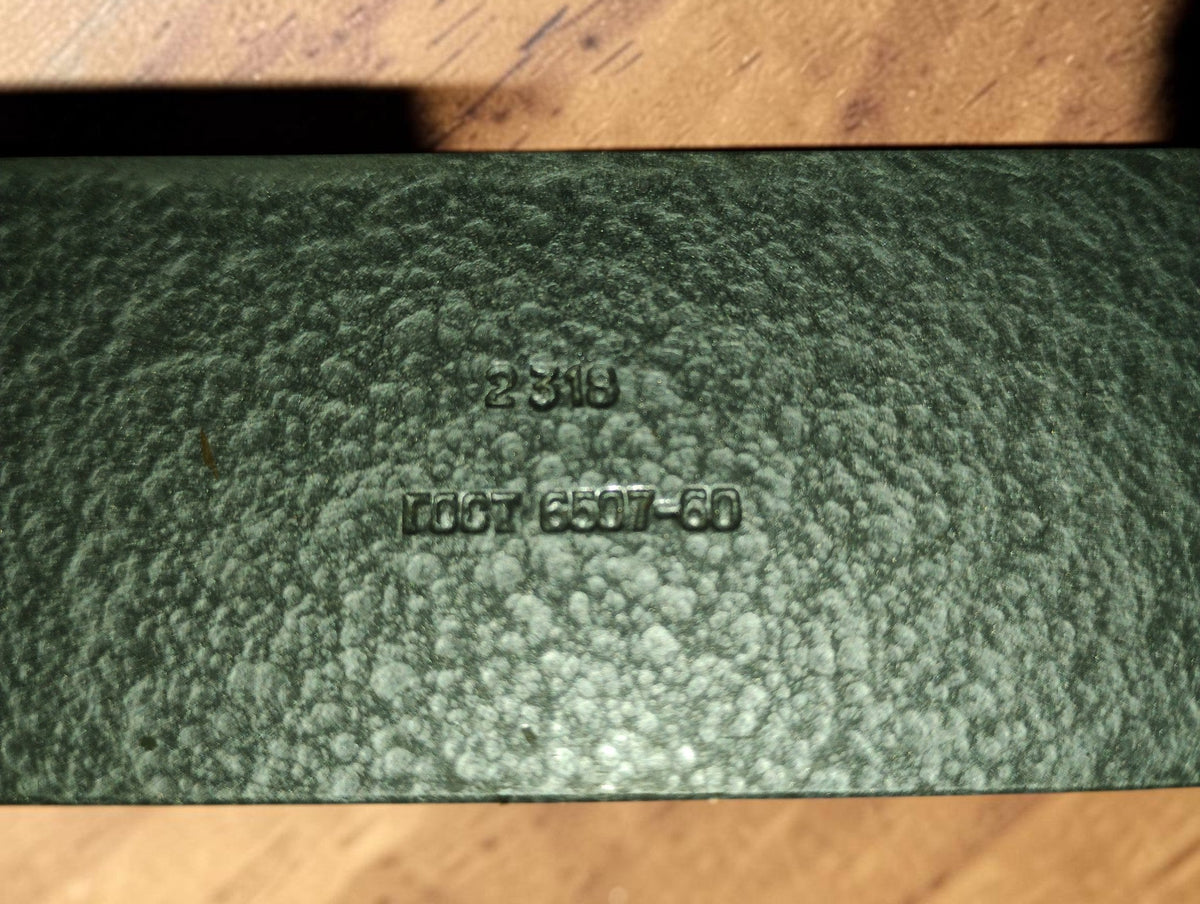 Detail of the textured green case lid showing a stamped number and the GOST 6507-60 reference.
