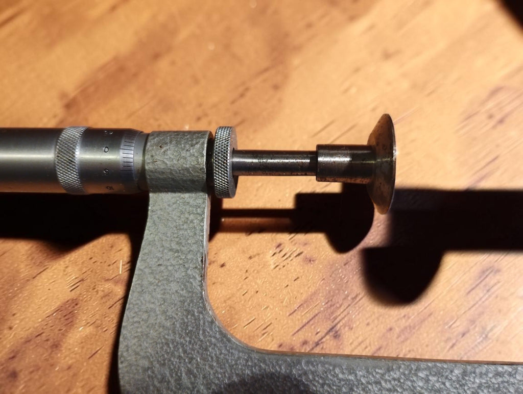 Close-up of the Soviet disc micrometer showing the graduated thimble, spindle and broad disc-shaped measuring face.
