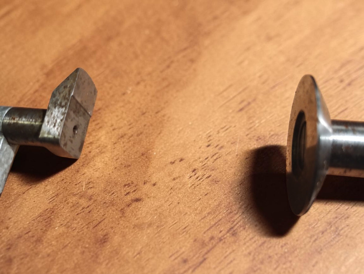 Detail of the micrometer's opposing broad measuring faces, showing surface wear from use.
