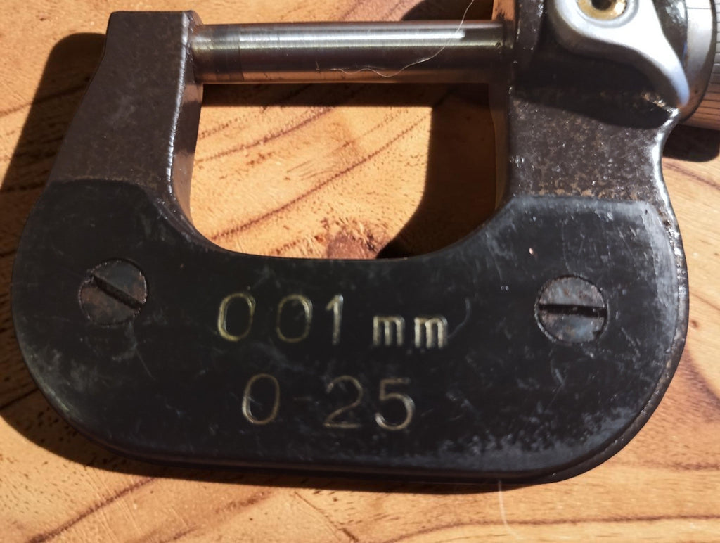 Close-up of the MAUSER junior micrometer frame marked 0–25 mm and 0.01 mm

