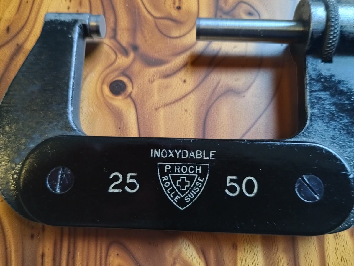 Close-up of the P. Roch Rolle Suisse maker’s mark, Swiss cross, Inoxydable marking and 25–50 range
