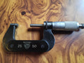 P. Roch Rolle Suisse 25–50 mm outside micrometer with black frame and silver-colored measuring thimble
