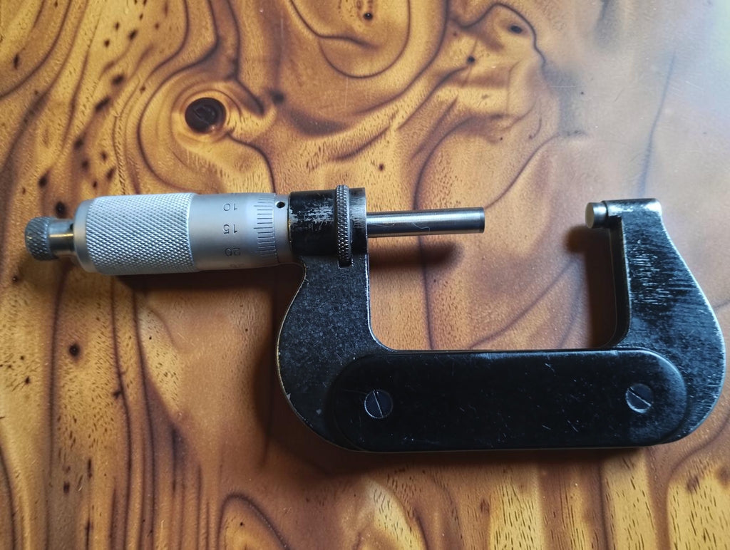 Reverse side of the P. Roch 25–50 mm outside micrometer showing wear to the black finish
