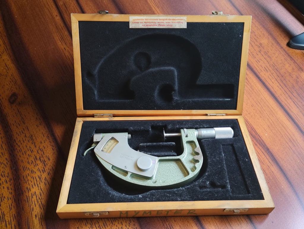 Mymeter 50–75 mm indicating micrometer in its fitted wooden case with a paper label inside the lid.
