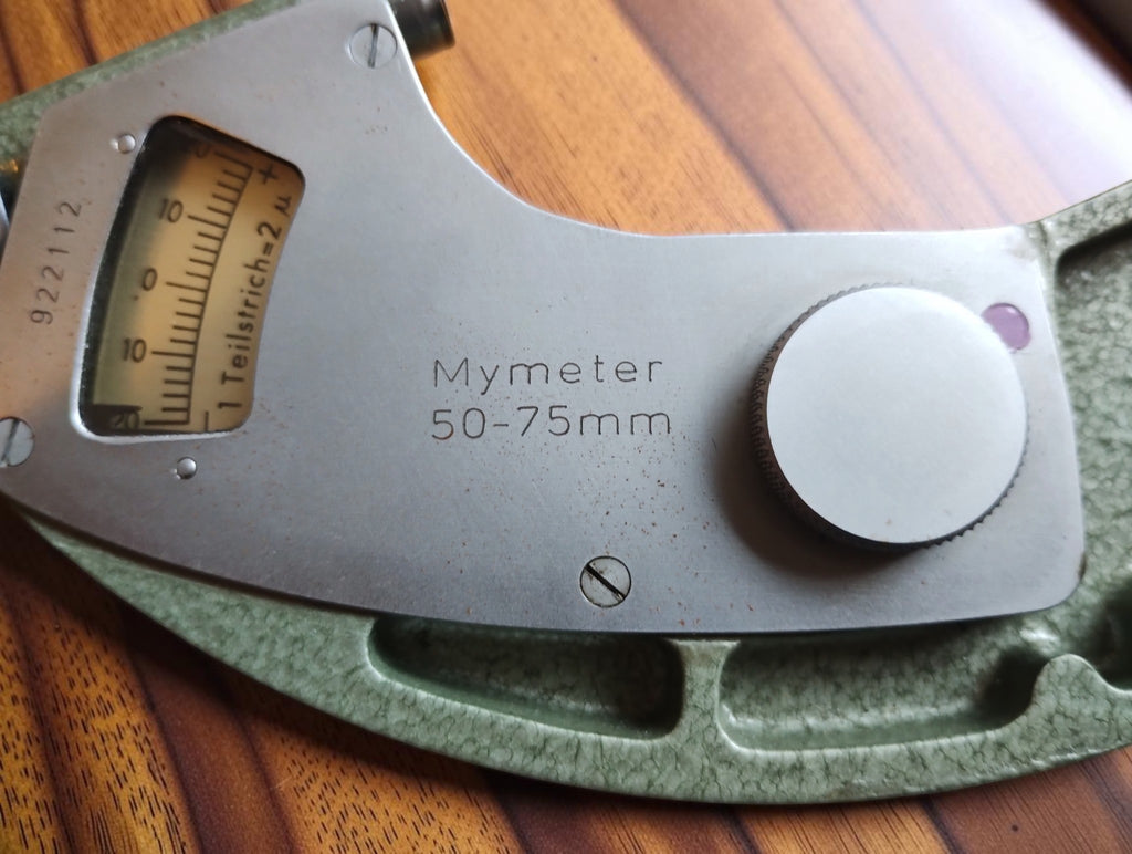 Mymeter 50–75 mm marking on the metal cover plate, with the indicator window and adjustment knob.
