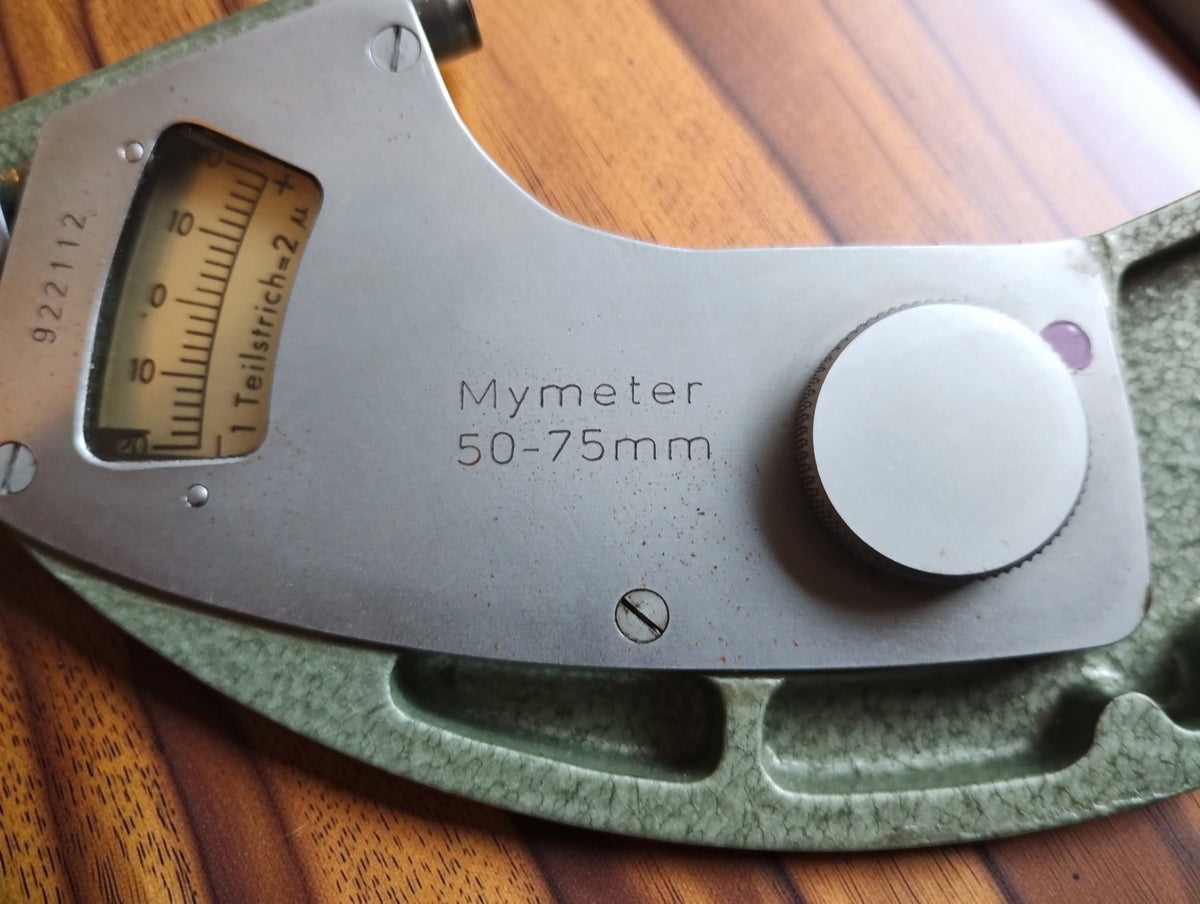 Mymeter 50–75 mm marking on the metal cover plate, with the indicator window and adjustment knob.
