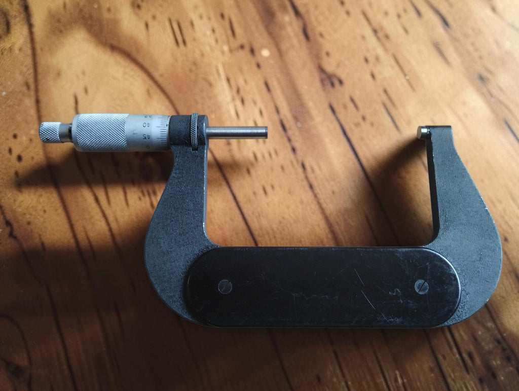 Side view of the P. Roch 75–100 mm outside micrometer showing the black grip plate and measuring spindle
