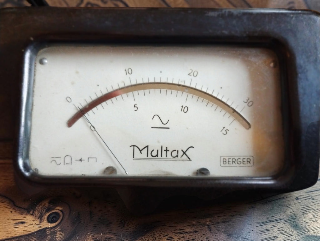 Close-up of the Multax Berger analog multimeter dial with dual scales and needle
