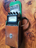 Hartmann & Braun Multavi 5 analog multimeter resting in its open cognac leather carrying case with green felt lining
