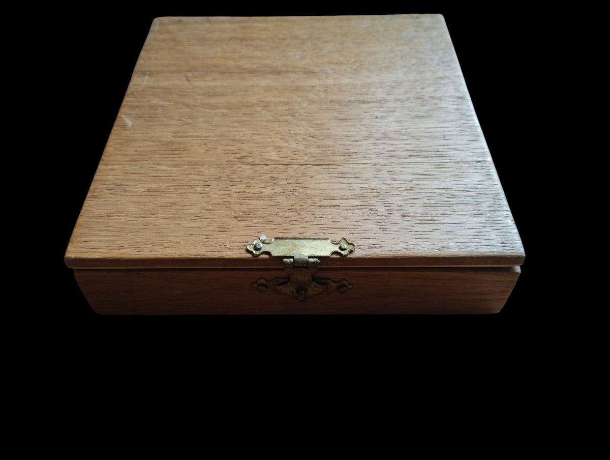 Closed wooden storage case for the ALRO 200R circular slide rule, with visible wood grain and a metal front clasp.
