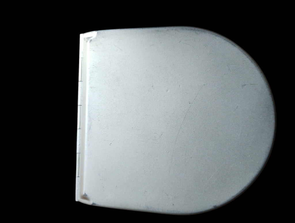 Closed metal housing of the ALRO 200R circular slide rule, showing its rounded lid, hinge and surface wear.
