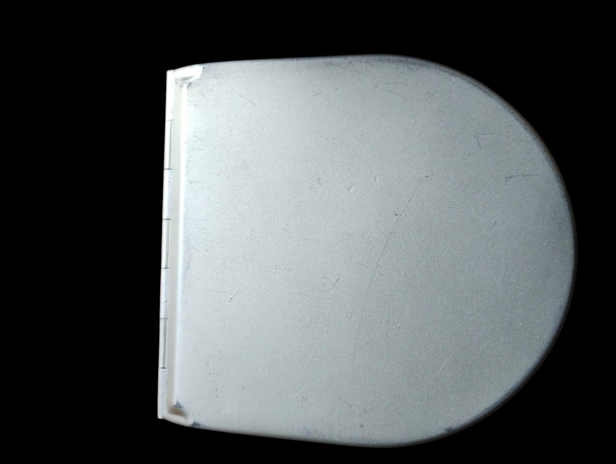 Closed metal housing of the ALRO 200R circular slide rule, showing its rounded lid, hinge and surface wear.
