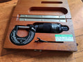 Brown & Sharpe No. 10 digit micrometer in an open wooden case with adjustment wrench and vintage calibration label
