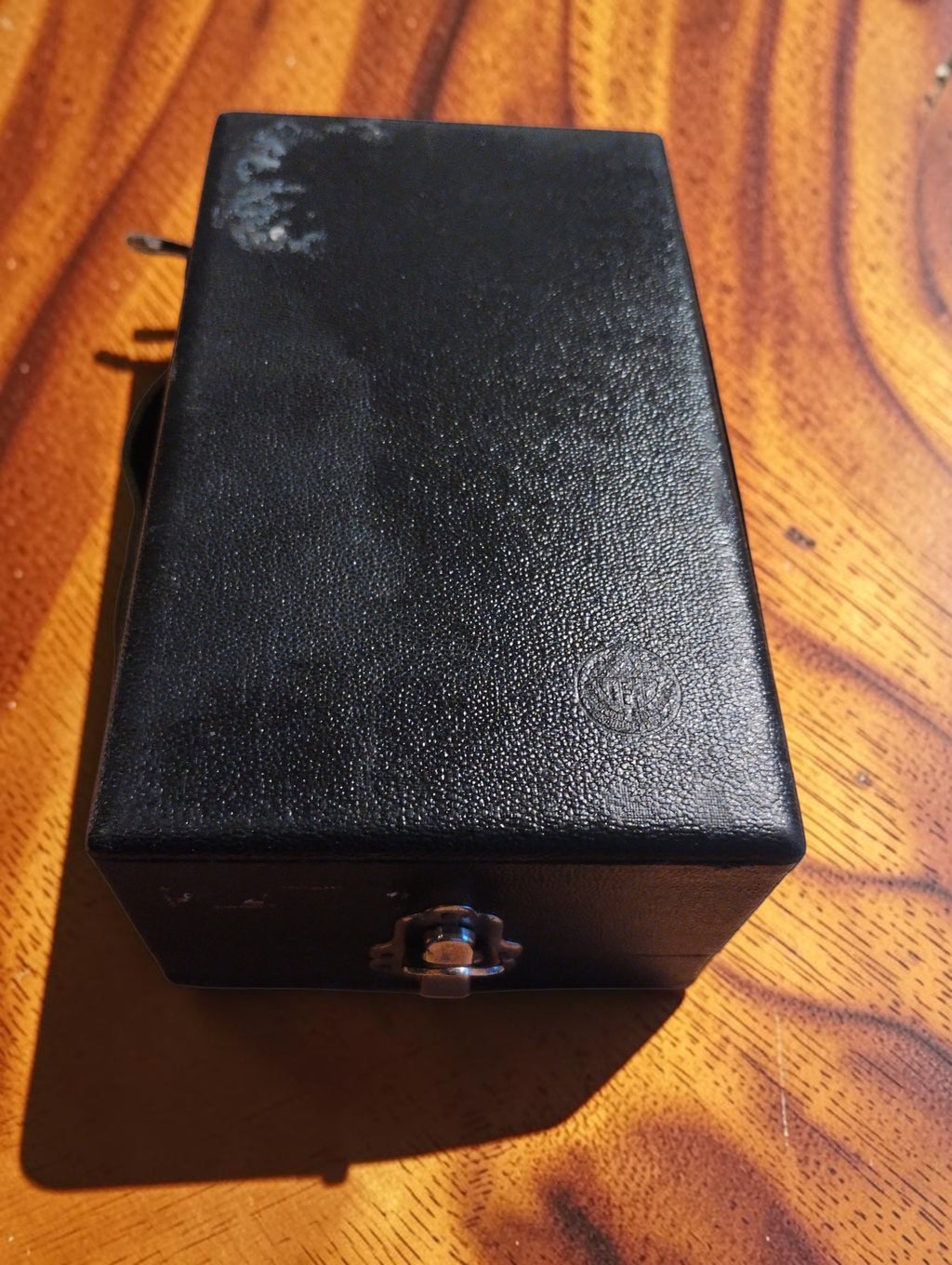 Closed black storage case for the MAW mechanical hand tachometer with front clasp and visible surface wear
