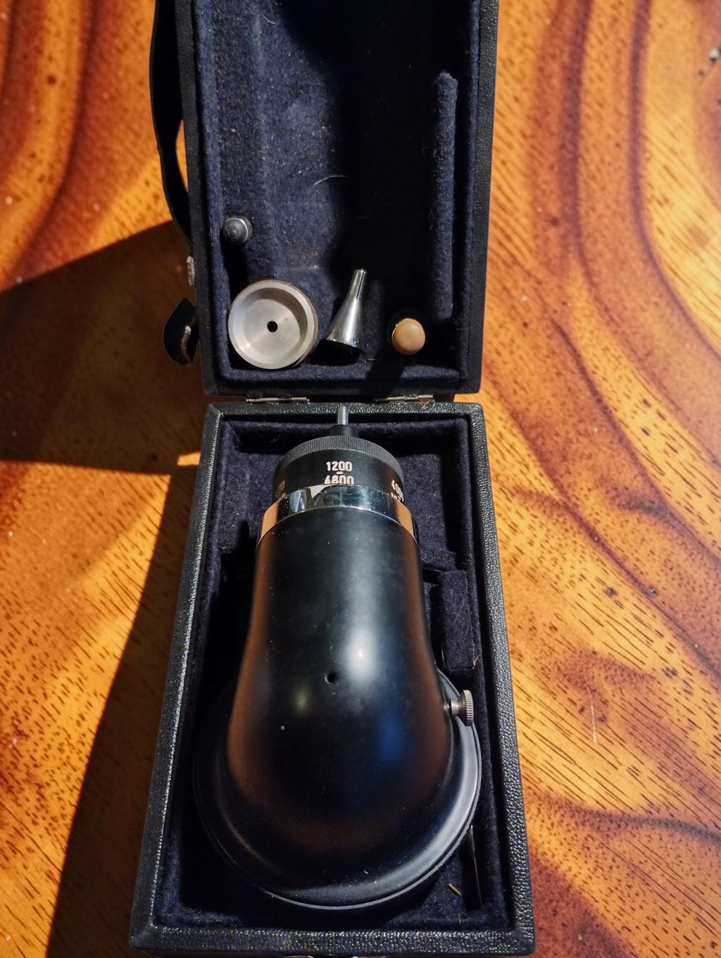 MAW hand tachometer resting in its open fitted case with contact attachments stored in the lid
