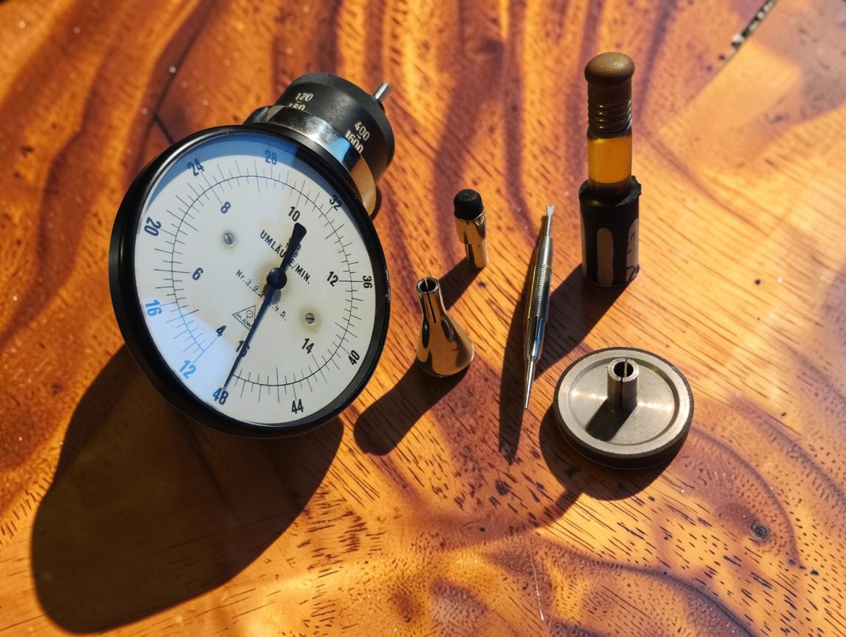 MAW DDR mechanical hand tachometer displayed with metal and rubber contact attachments, extension tool and accessory container

