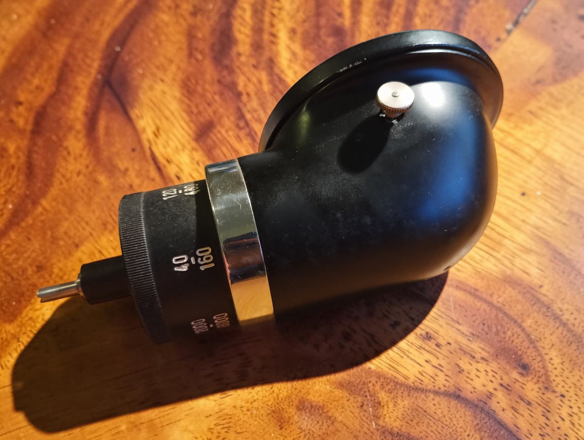 Side and rear view of the black MAW hand tachometer showing the chrome ring and drive spindle

