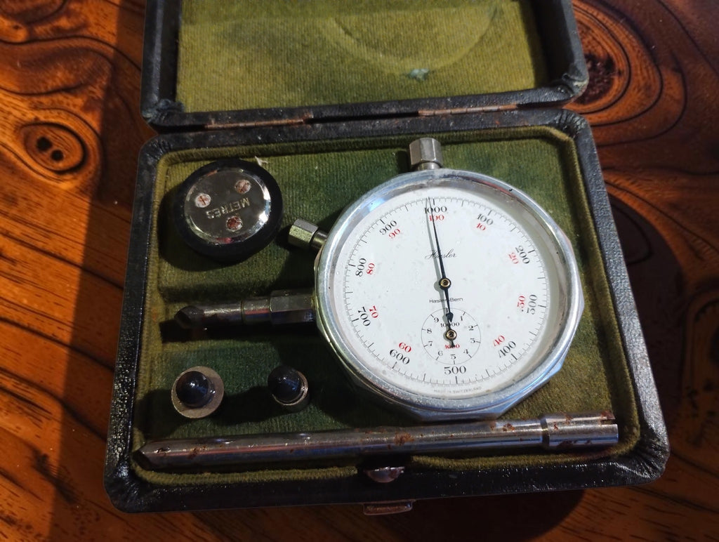 Hasler Bern hand tachometer in an open green-lined case with contact tips and accessories
