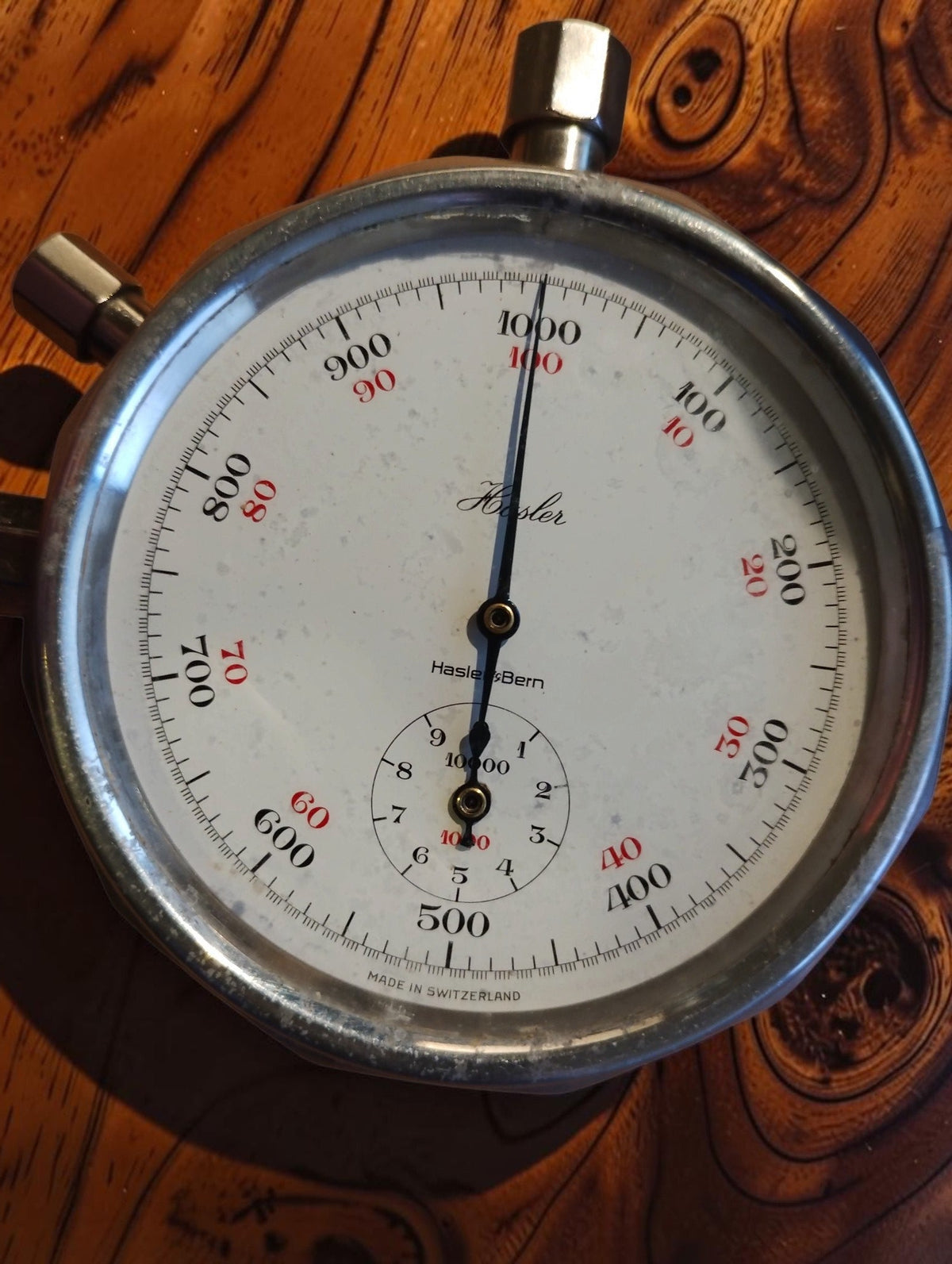 Hasler Bern Swiss-made tachometer dial with red and black scales and a smaller counter dial
