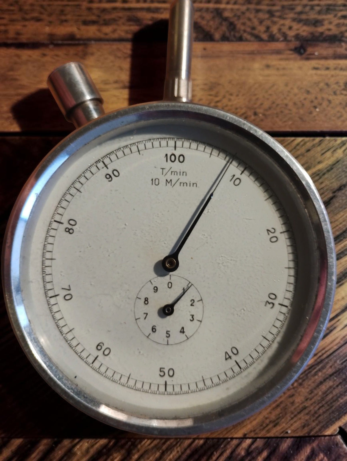 Close-up of the N. Zivy & Cie hand tachometer dial with T/min and M/min markings and a small subsidiary dial
