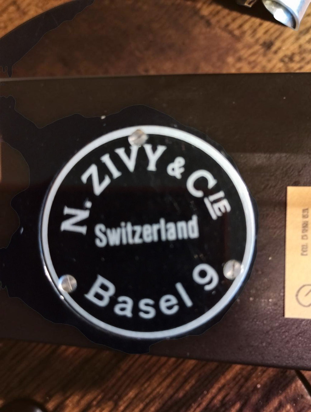 Round metal maker’s plate on the back of the instrument, marked N. Zivy & Cie, Switzerland, Basel 9
